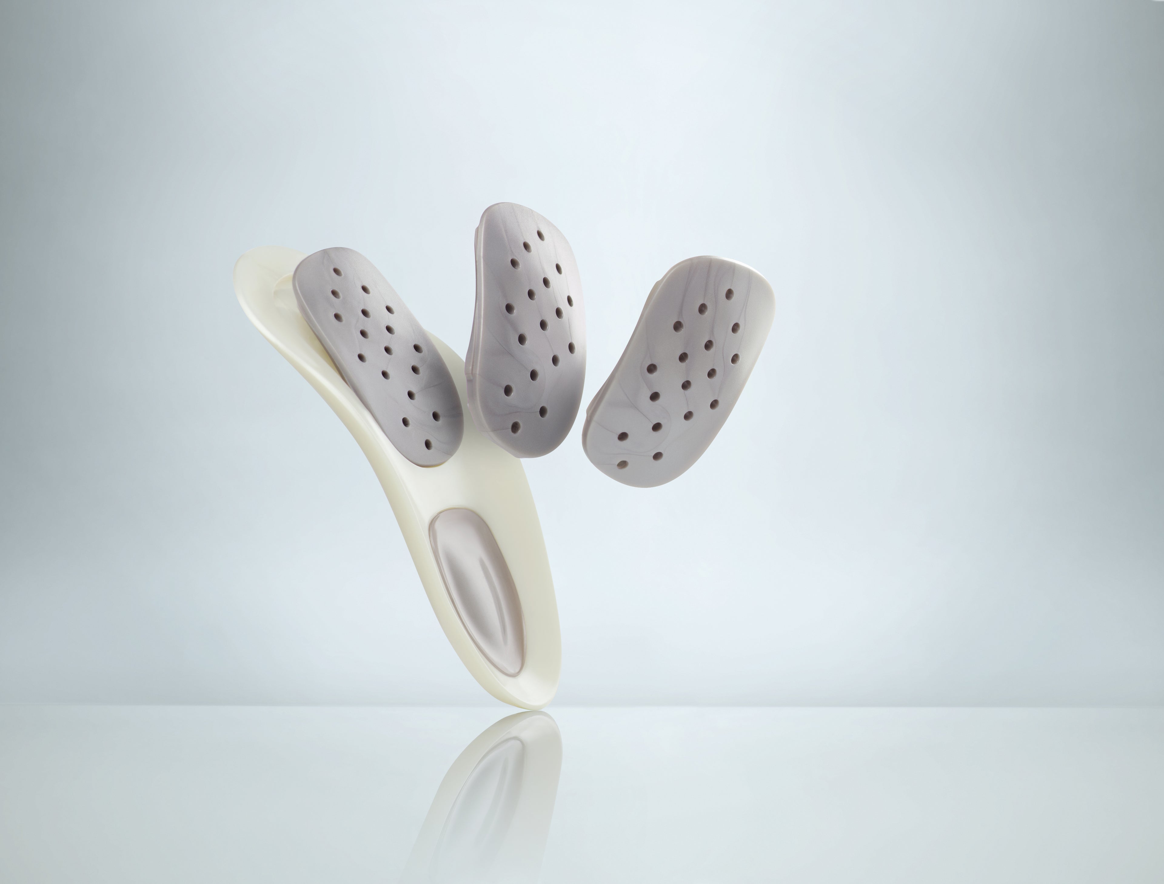 Customizable WalkFit Platinum orthotic insole with three adjustable arch inserts.